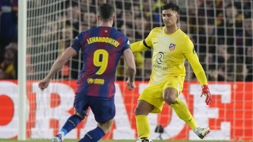 El guardameta argentino del Atlético de Madrid, Juan Musso (d), despeja el balón ante el delantero polaco del FC Barcelona, Robert Lewandowski, durante el encuentro correspondiente a la ida de los cuartos de final de la Liga de Campeones