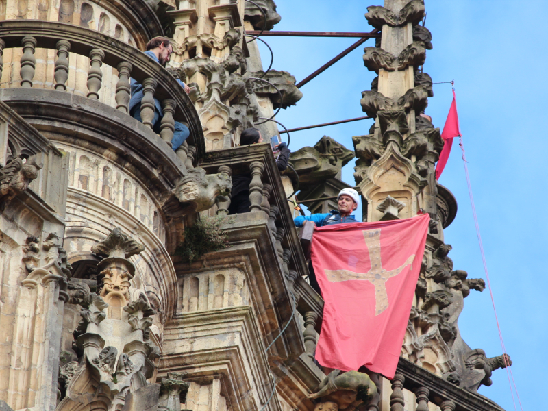 El montañero Joaquín Álvarez coloca las banderas rojas por el Jubileo en la Catedral de Oviedo