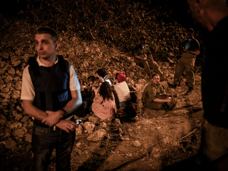 Personas se resguardan en el lateral de una carretera de Tel Aviv durante el ataque iraní