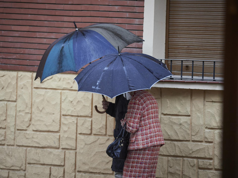 Dos personas se protegen de la lluvia con paraguas