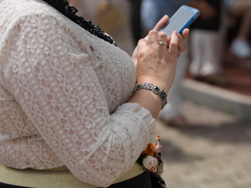 Una mujer está usando un teléfono.