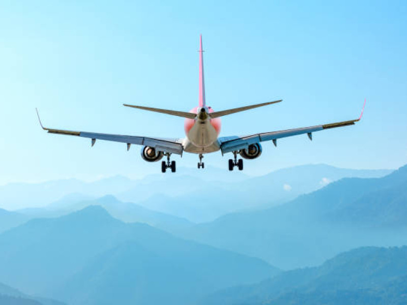 airplane fly above amazing blue misty mountains, jet flight travel concep