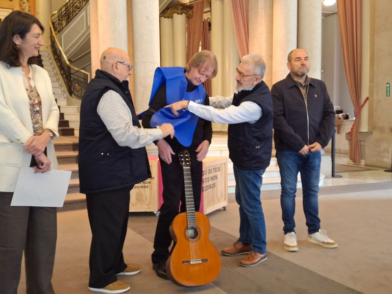 Russell recibiendo el peto azul del Banco de Alimentos