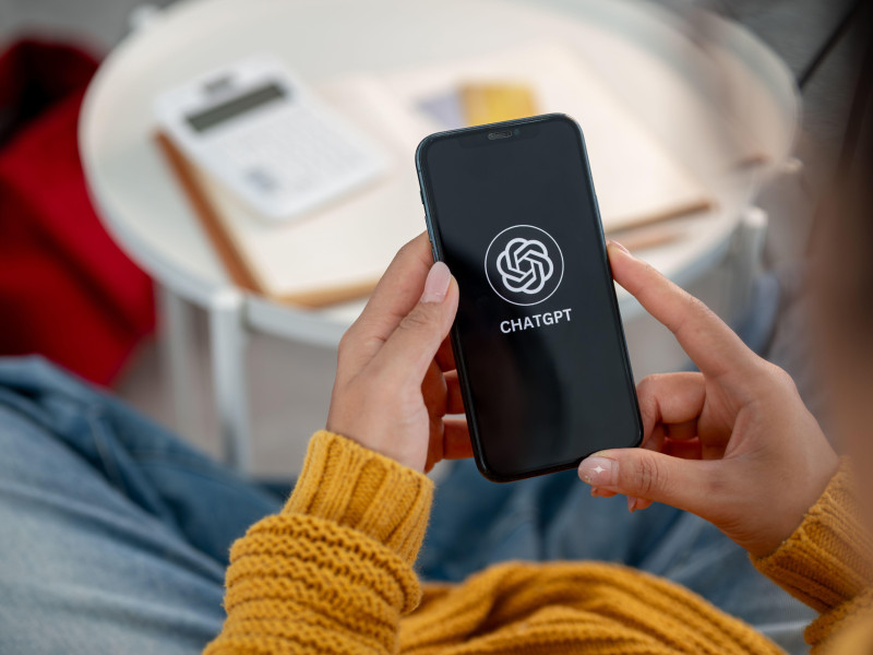 Una mujer utilizando la aplicación de ChatGPT en su teléfono móvil