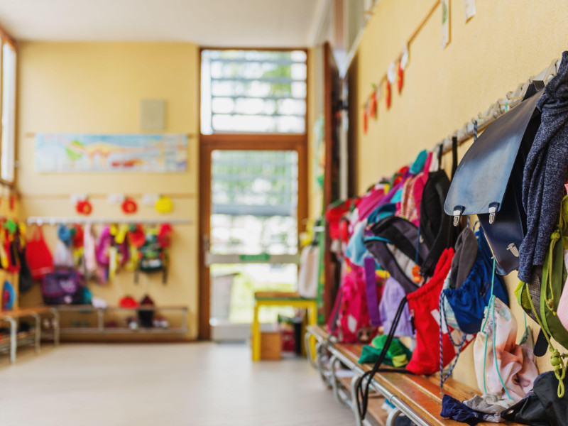 Mochilas de niños colgadas en un aula de guardería