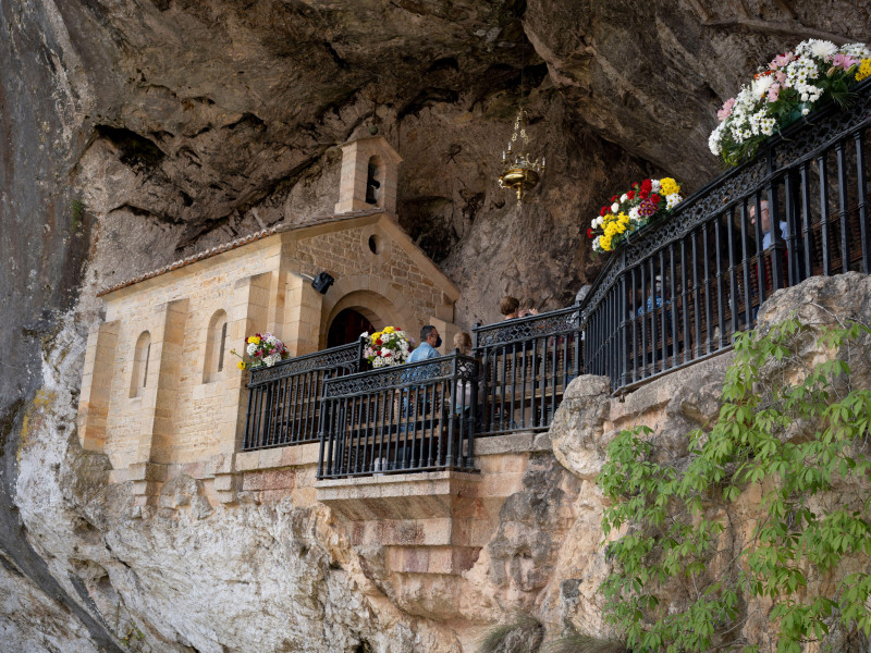 Fieles cristianos visitan la Santa Cueva de Nuestra Señora de Covadonga (la Santa Cueva de Nuestra Señora de Covadonga), un santuario católico en un acantilado