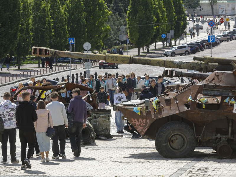 Gente caminando entre vehículos militares por Kiev