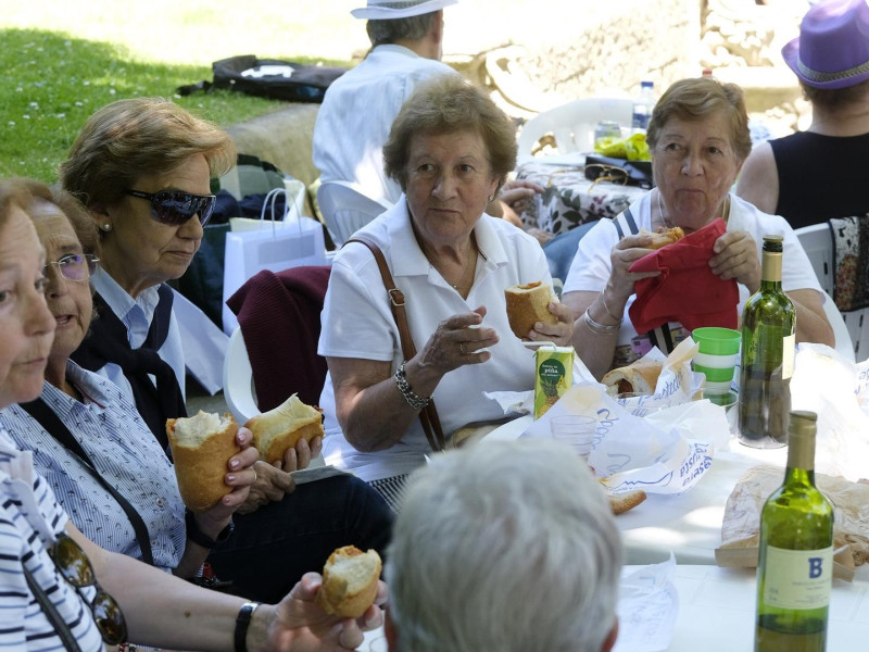 Señoras comiendo los  bollos preñados en la fiesta del Martes de Campo