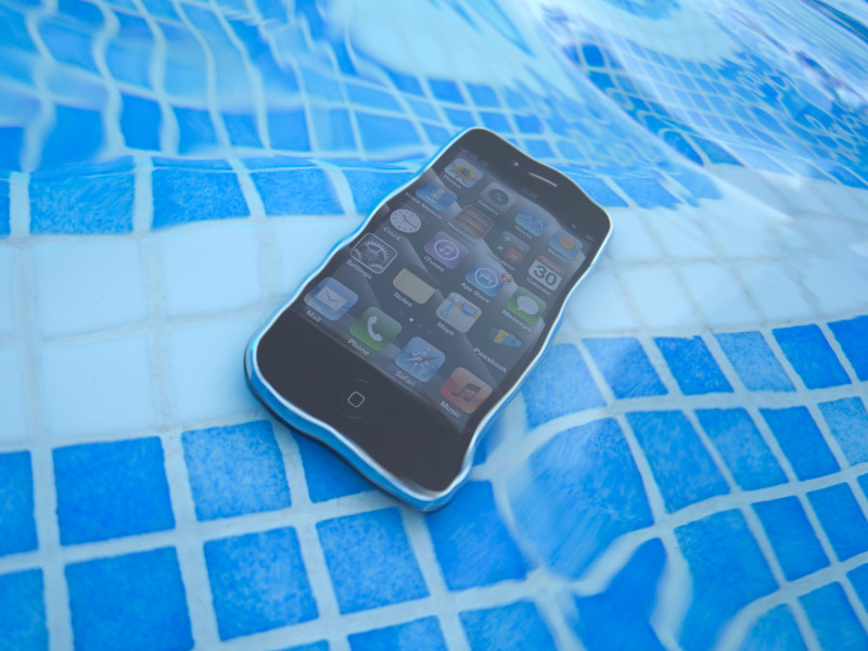 Un teléfono sumergido en el fondo de una piscina