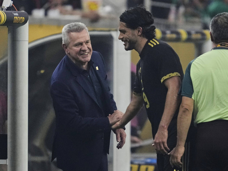 Mexico head coach Javier Aguirre, left, and Raúl Jiménez, right, shake hands in the second half of the CONCACAF Gold Cup final soccer match against the United States in Houston, Sunday, July 6, 2025. (AP Photo/Ashley Landis)