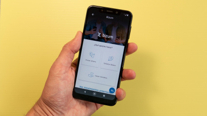 Servicios de pago con la app Bizum. Mano sujetando el móvil.