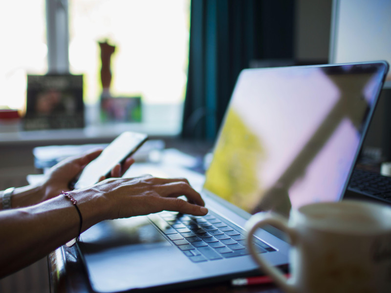 2C79CAW Close up woman working from home at laptop in home office