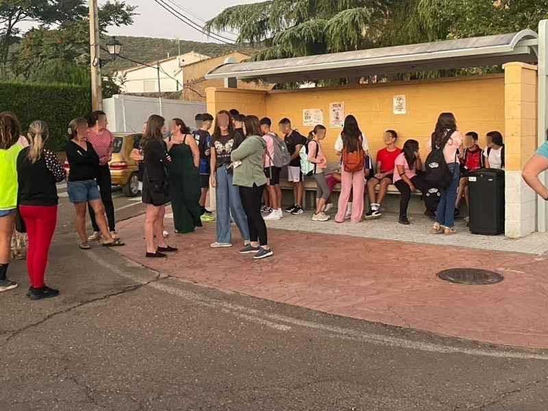Madres y alumnos en la parada del autobús escolar de La Morera