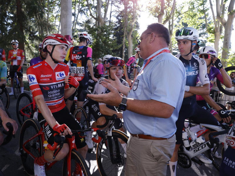 El comisario de la UCI Thierry Diederen comunica a los corredores la finalización de la Vuelta a España
