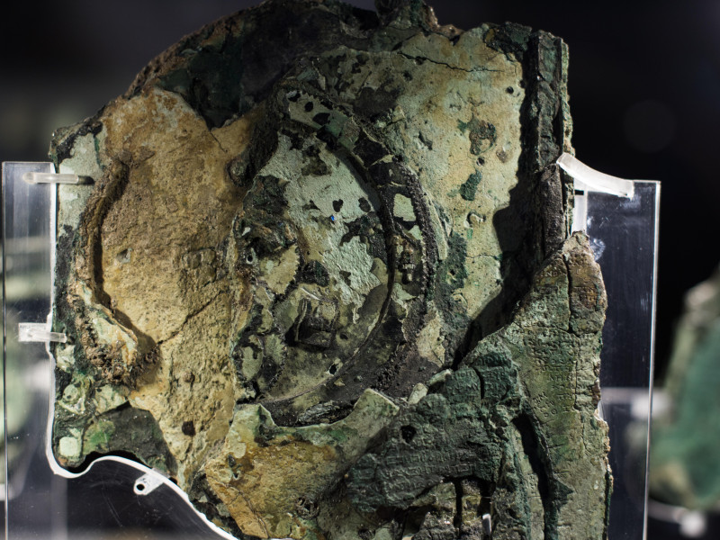 G2B5WR Antikythera Mechanism Fragment National Archaeological Museum Athens Greece // ATHENS, Greece ? One of the highlights of the National Archaeological Museum in Athens, Greece, the Antikythera Mechanism now has its own dedicated exhibit gallery in which all of its fragments are on display. Believed to date to somewhere around 100 BC to 205 BC, it was found amongst a large cache of statues, coins, and other artefacts on a sunken shipwreck discovered in 1900 by sponge divers off the coast of the Greek island of Antikythera. It was badly damaged after such a long time in the salt water, but extensi