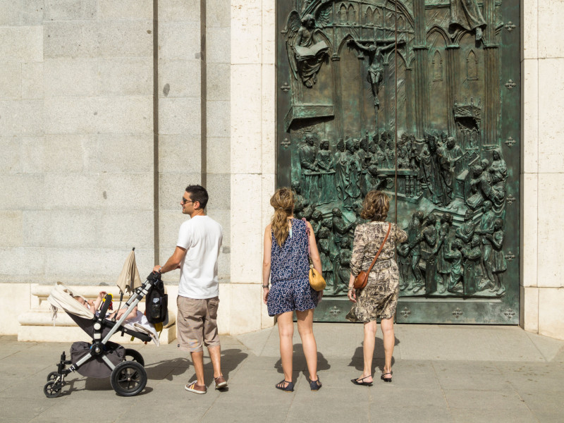 Una familia con su hijo fuera de la Catedral de Santa María La Almudena la Real de Madrid, Madrid