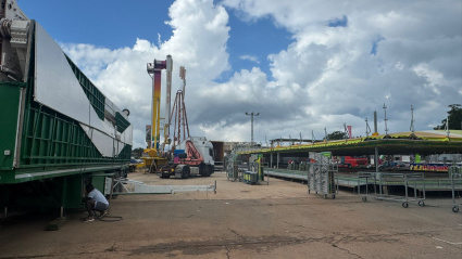 Operarios trabajan en el montaje de las atracciones de la Fira de Tots Sants, que abrirá sus puertas este viernes en la explanada de Torrecremada