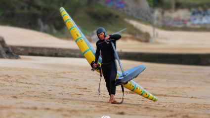 Koti Valdés sacando el material por la playa de Los Peligros