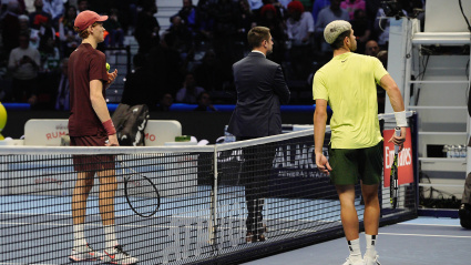 Jannik Sinner y Alcaraz hablan con el juez de silla durante un momento del partido.