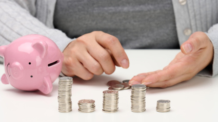 Mujer contando en dinero que ha sacado de una hucha