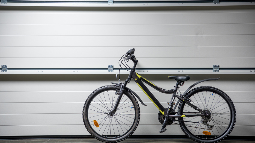 Mountain bike standing indoors at grey wall
