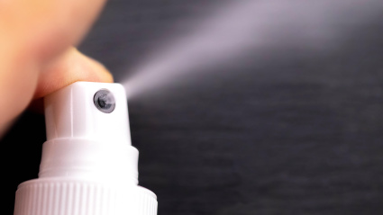 T5EFWH nasal spray pressed with finger, close up detail