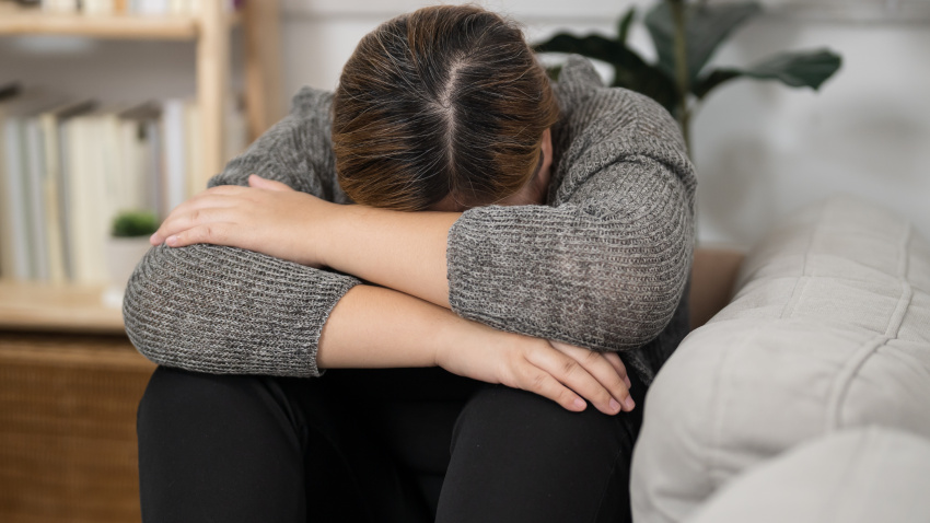 Sad Overweight plus size woman thinking about problems on sofa upset girl feeling lonely and sad from bad relationship or Depressed woman disorder mental health