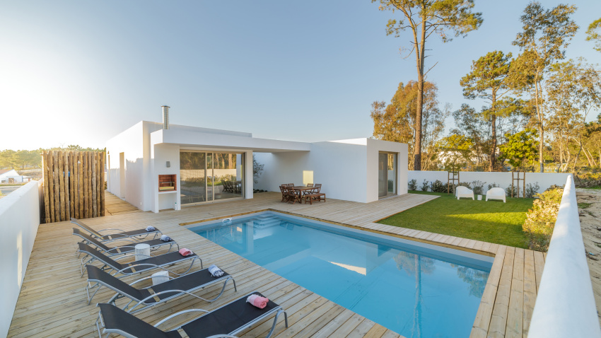 Modern house with garden swimming pool and wooden deck