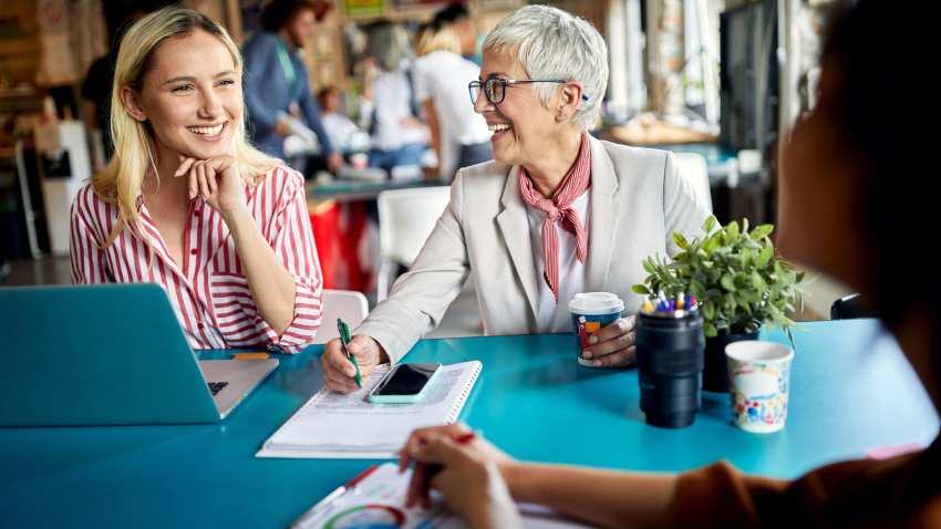 Empleada que asesora a los trabajadores jóvenes en la oficina