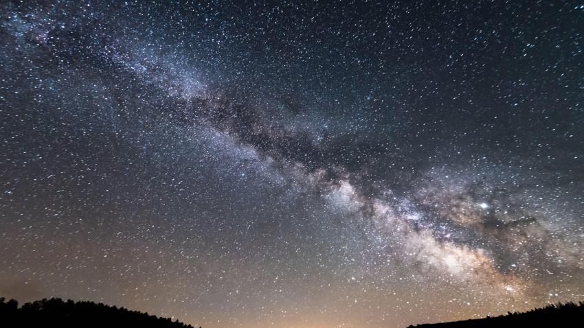 Fotografía de larga exposición de la Vía Láctea y su centro galáctico en un bosque cerca de la localidad de Villardeciervos y Boya en Sierra de la Culebra, Zamora.