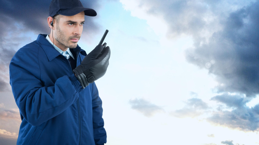 Composición digital de un guardia de seguridad en el exterior con cielo nublado.