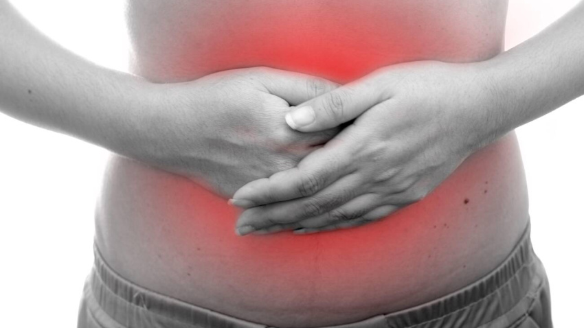 2APMND1 Young Asian woman with abdominal pain at white background, Women getting a stomach ache, health problem discomfort diarrhea concept