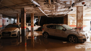 VehÍculos en el interior de un garaje del que ya se ha achicado todo el agua este lunes en Paiporta