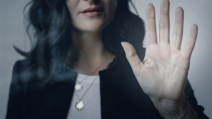 Woman with a beautiful hand touching the window