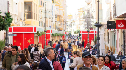 Centenares de personas recorren la calle Corredera durante la  inauguración del Mercado de Navidad