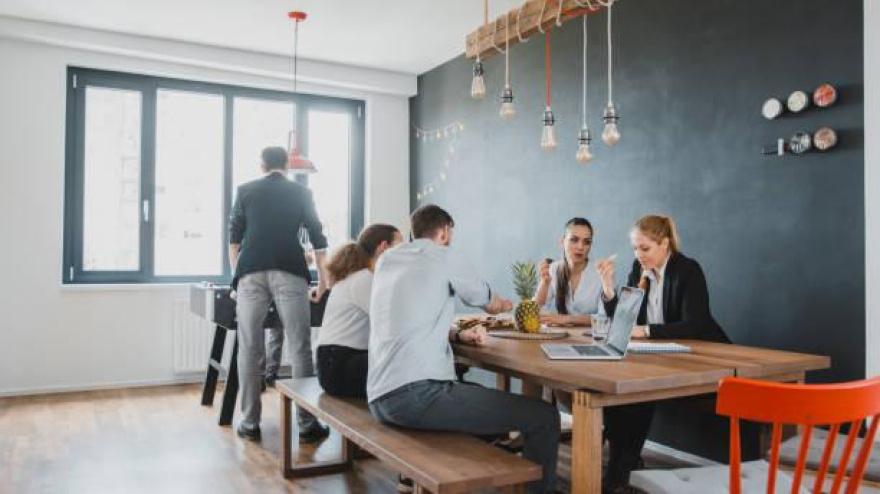 Business colleagues talking during their break in the kitche