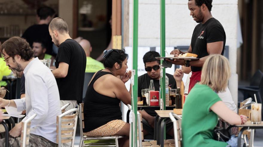 Un camarero atiende una terraza
