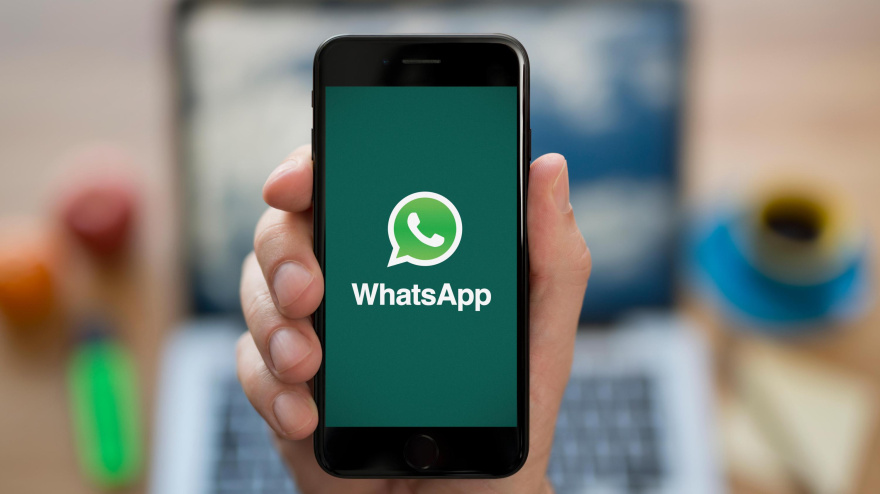 Un hombre sujeta su móvil con el logo de WhatsApp en la pantalla