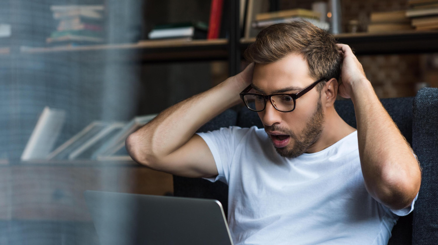 Un chico en shock utilizando su ordenador
