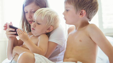 Niños usando el teléfono celular juntos