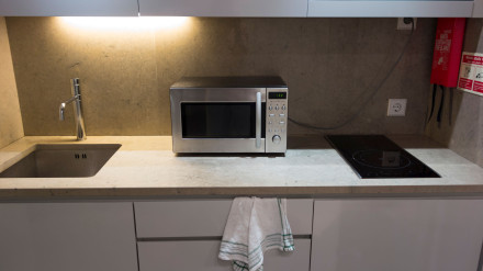 DGA8CK Small modern white kitchen counter with microwave oven