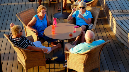 ENTHN8 Senior couples relax on the deck of a cruise ship