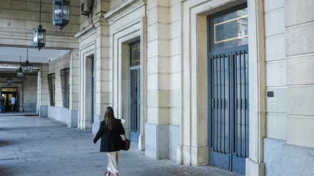 Archivo - Una mujer camina hacia la Audiencia de Sevilla en imagen de archivo.