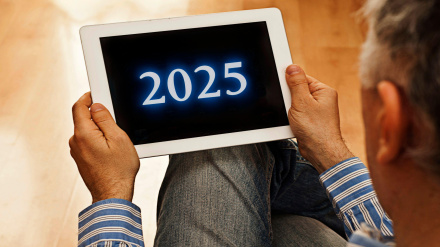 2YE20WN man with a tablet showing a 2025 on the screen