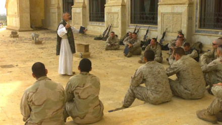 April 19th, 2003:   7th Marine Regiment Chaplin, Father Bill Devine, Boston, Massachusetts speaks to Marines from 5th Marine Regiment during Catholic Mass at one of Saddam Hussein's palaces in Tikrit, Iraq in support of Operation Iraqi Freedom.  1st Light Armored Reconnaissance Batalion is part of the 1st Marine Division from Camp Pendleton, California.  Operation Iraqi Freedom is the multinational coalition effort to liberate the Iraqi people, elliminate Iraq's weapons of mass destruction and end the regime of Saddam Hussein.(Official USMC photograph by LCpl Andrew P. Roufs)(RELEASED)