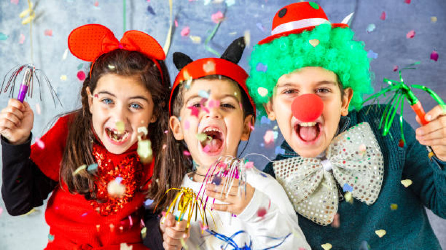 Three kids celebrating Carnival  together at hom