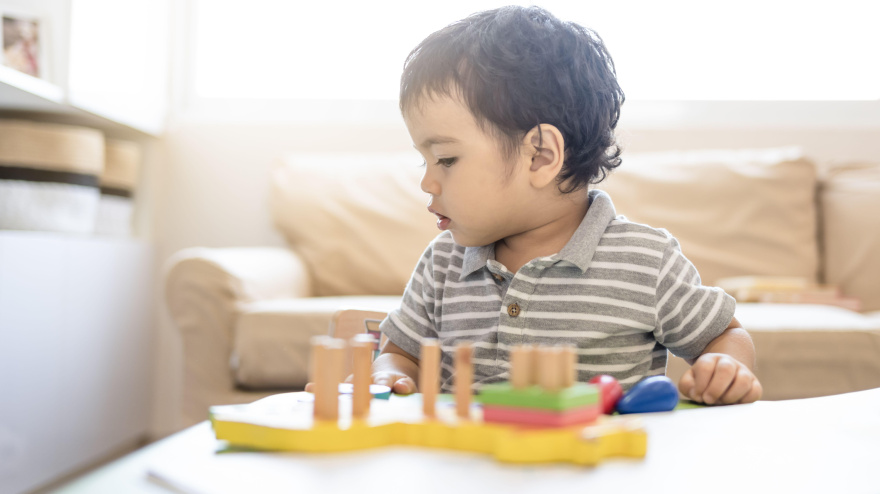 Niño con juguetes educativos en la sala de estar