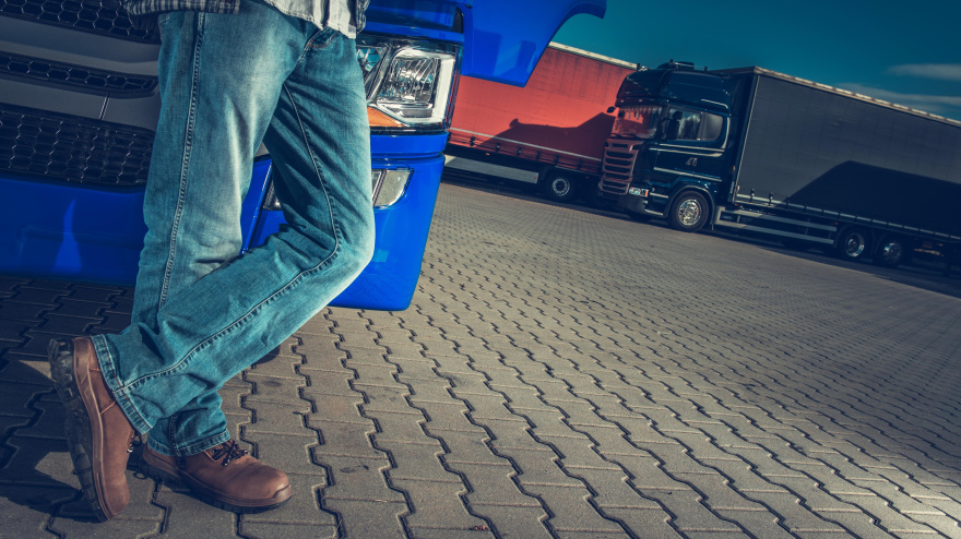 Conductor de camión y parada de camiones. Tema de la industria del transporte.