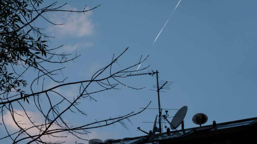 An intercept missile tracks and chases an incoming Iranian missile as seen over Jerusalem rooftops.
