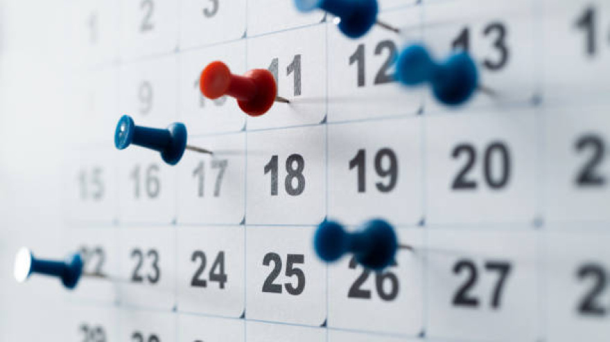 Thumbtack pins on a calendar